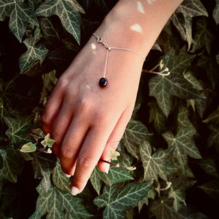 Silver chain bracelet with sliding bead and dangling porcelain drop