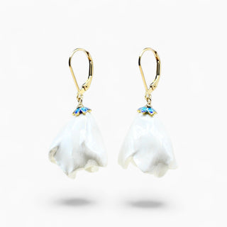 A pair of white lily of the valley drop earrings with gold leverback hooks and small blue flower accents, shown on a clean white background.
