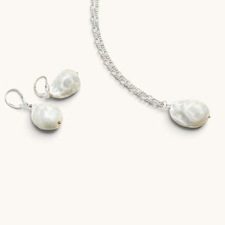 Matching pearlescent white porcelain earrings and pendant necklace set with silver-coloured chain