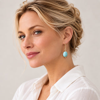 Blonde model wearing turquoise porcelain earrings with a white blouse, showing their elegant 5 cm drop.