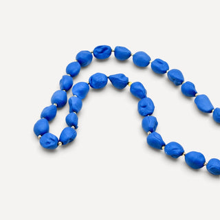 Matte navy blue porcelain pearl necklace with gold detailing, a distinctive porcelain anniversary gift for her.