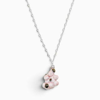 Pink botanical porcelain pendant on a matinee-length silver chain, an artistic anniversary gift for a wife