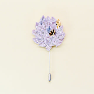 Lavender flower-shaped brooch handmade from porcelain with a gold leaf on a beige background