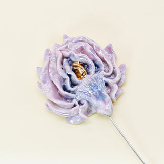 Decorative porcelain blush artichoke flower handmade brooch with a gold heart on a beige background