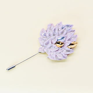 Unique handmade porcelain flower-shaped pink brooch with gold accents on a beige background