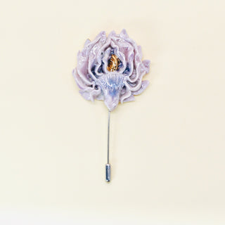 Elegant handmade porcelain pink artichoke flower lapel pin on a beige background