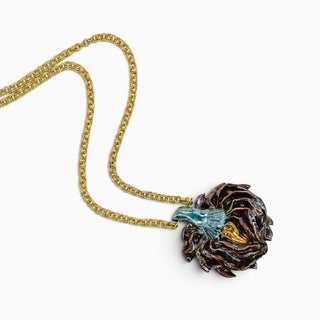Handmade artichoke heart necklace with chocolate-brown and green glass glaze on an elegant female model