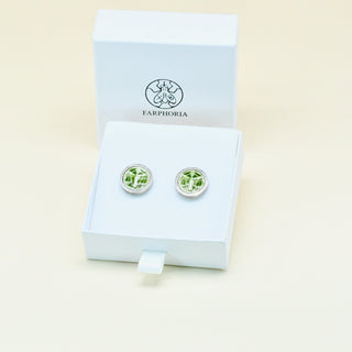 Green round porcelain Libra zodiac cufflinks with stainless steel setting on a display box with 'Farphoria' branding against a light beige background.