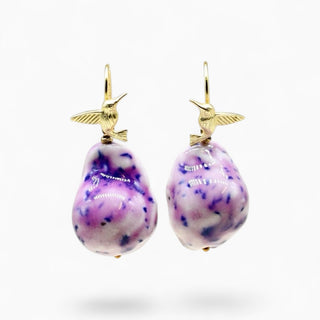 A pair of handmade hummingbird earrings in porcelain and gold, a thoughtful luxury gift for a sister