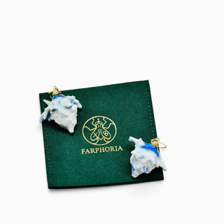 A pair of Farphoria thistle earrings displayed on a dark green branded pouch -beautiful birthday present