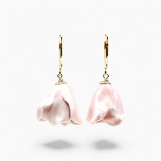 A pair of dangling earrings with soft pink flower-shaped charms and gold leverback hooks - the best gift for girlfriend 