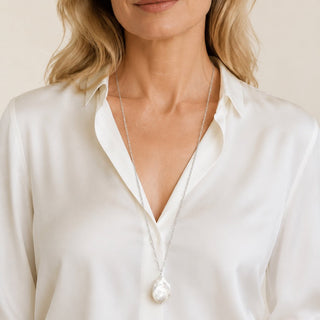 FARPHORIA porcelain pendant necklace styled with an elegant white silk blouse